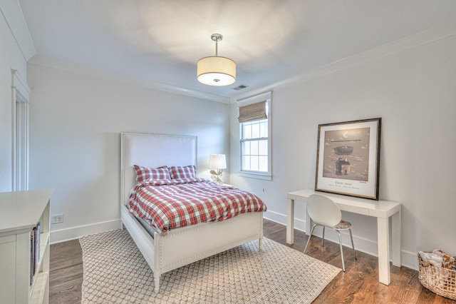 bedroom featuring dark hardwood / wood-style flooring and ornamental molding