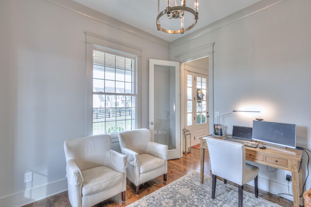 office featuring hardwood / wood-style floors and an inviting chandelier