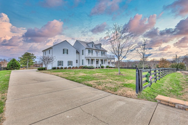 view of front of house with a porch and a yard