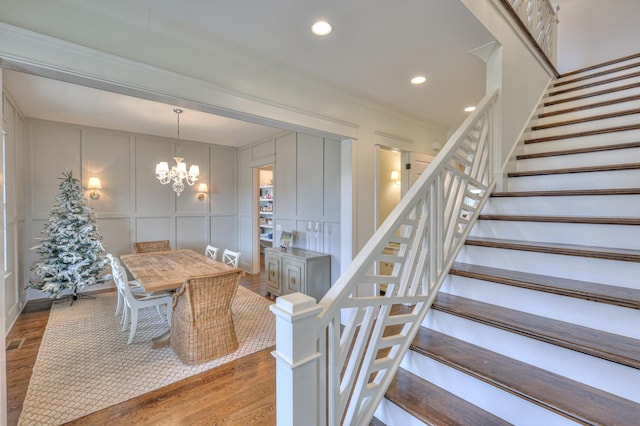 dining area featuring hardwood / wood-style floors and a notable chandelier