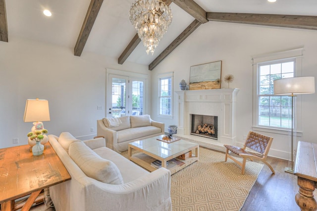 living room featuring hardwood / wood-style flooring, beamed ceiling, high vaulted ceiling, and an inviting chandelier