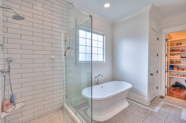 bathroom with tile patterned floors, crown molding, and shower with separate bathtub