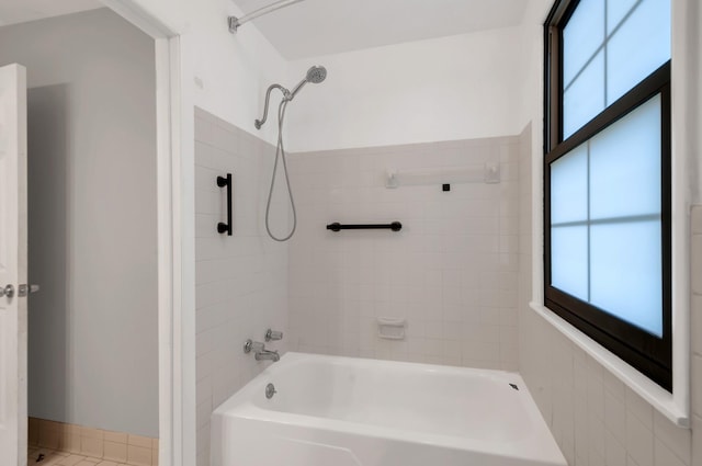 bathroom with tile patterned flooring and tiled shower / bath