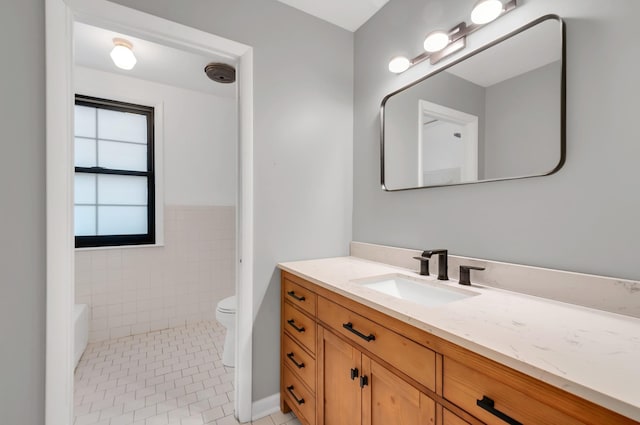 bathroom featuring tile patterned flooring, vanity, and toilet