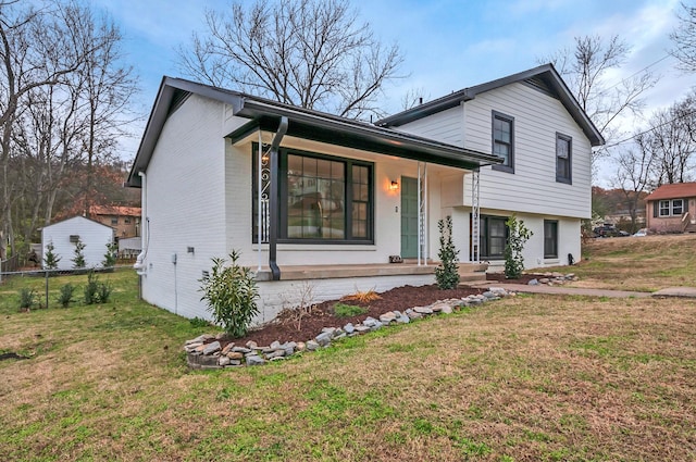 tri-level home featuring a front yard and a porch