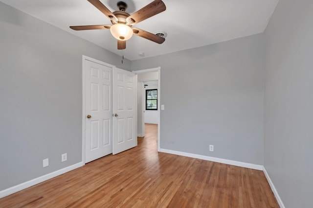 unfurnished bedroom featuring light wood-type flooring and ceiling fan