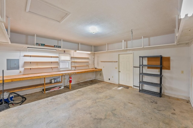 basement featuring a workshop area, a textured ceiling, and electric panel