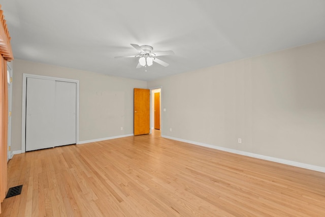 spare room featuring light hardwood / wood-style floors and ceiling fan