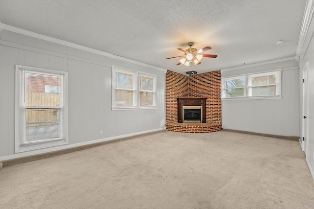 unfurnished living room featuring ornamental molding, light colored carpet, and a healthy amount of sunlight