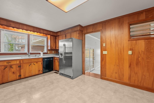 kitchen with stainless steel refrigerator with ice dispenser, black dishwasher, a wealth of natural light, and wood walls