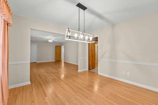 unfurnished dining area with ceiling fan and light hardwood / wood-style floors