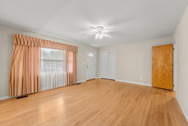 spare room with ceiling fan and light wood-type flooring