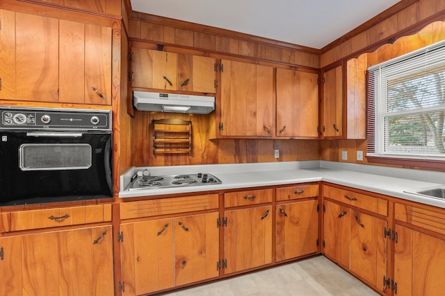 kitchen featuring black oven, crown molding, and white gas stovetop