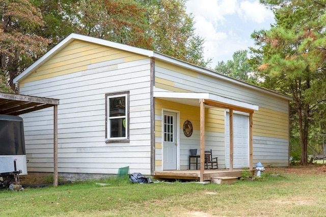 back of property with a lawn