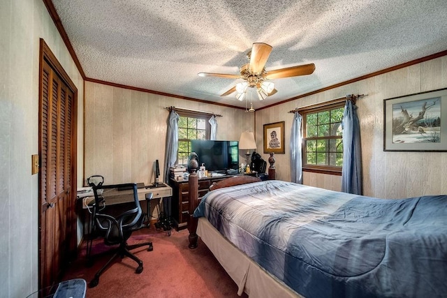 carpeted bedroom featuring a textured ceiling, multiple windows, ornamental molding, and ceiling fan