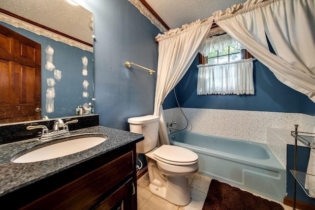 bathroom featuring tile patterned floors, vanity, a textured ceiling, toilet, and a bathing tub