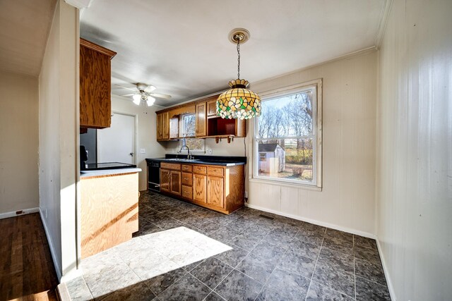 kitchen featuring ceiling fan, sink, black dishwasher, crown molding, and pendant lighting