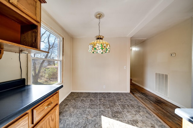 unfurnished dining area with crown molding and dark hardwood / wood-style floors