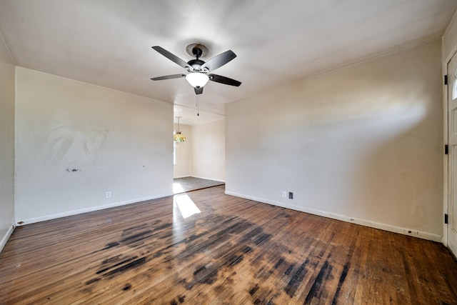 unfurnished room with ceiling fan and dark hardwood / wood-style flooring