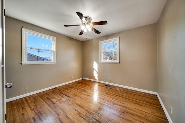 unfurnished room with ceiling fan and hardwood / wood-style flooring