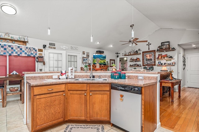 kitchen with sink, light hardwood / wood-style flooring, dishwasher, lofted ceiling, and an island with sink