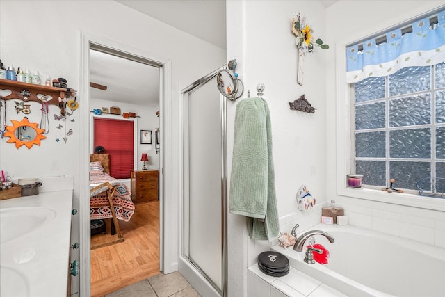 bathroom featuring hardwood / wood-style flooring, sink, and plus walk in shower