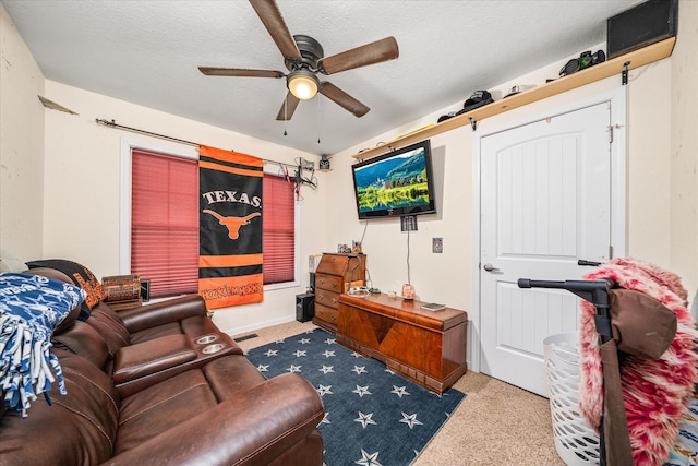 living room featuring ceiling fan and a textured ceiling