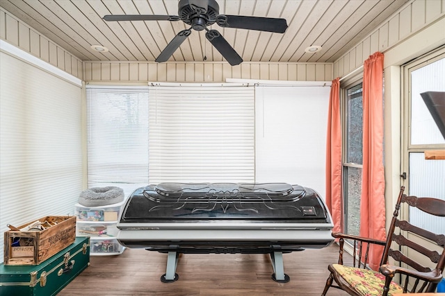 miscellaneous room with ceiling fan, wooden walls, wood ceiling, and hardwood / wood-style flooring