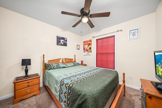 carpeted bedroom with ceiling fan and a textured ceiling