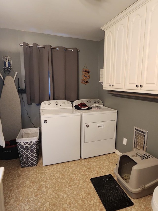 clothes washing area with washing machine and dryer