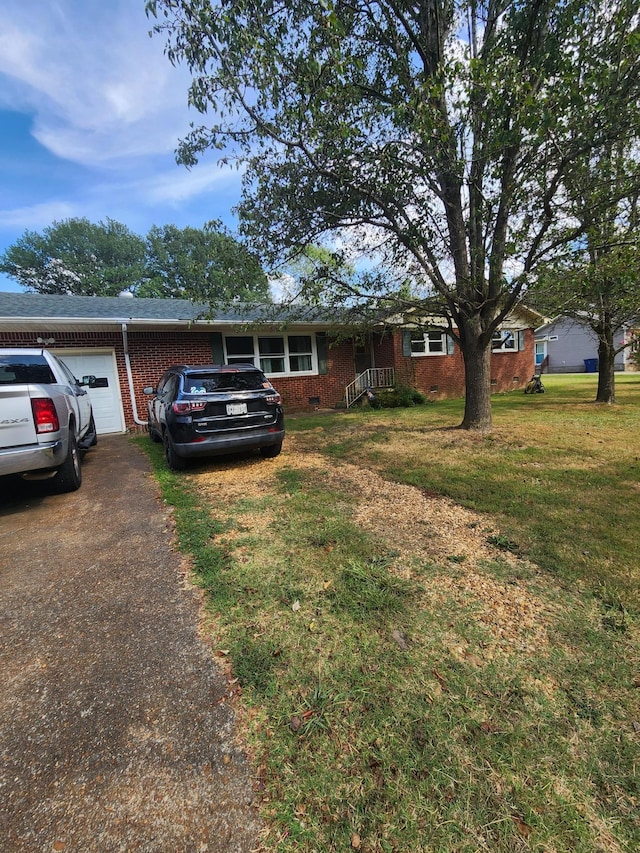 single story home with a garage and a front yard