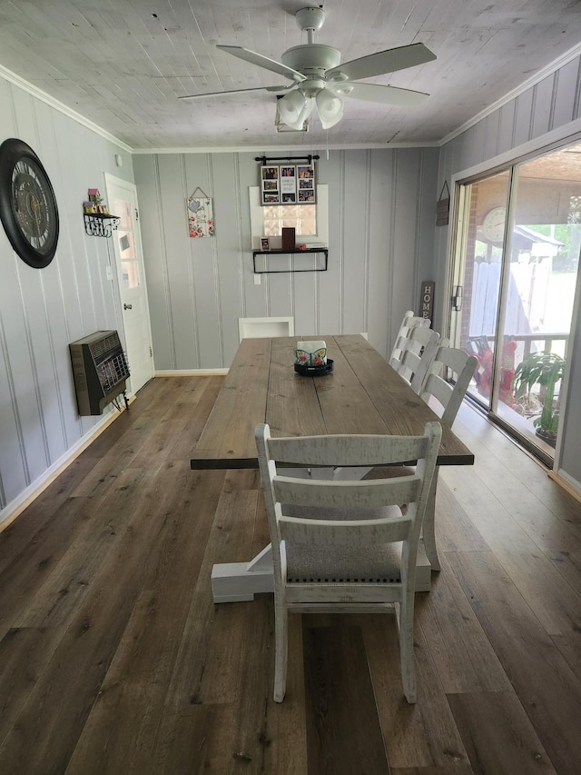 dining room with wood-type flooring, heating unit, ceiling fan, and crown molding