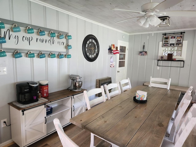 dining room featuring dark wood-type flooring, ceiling fan, and ornamental molding