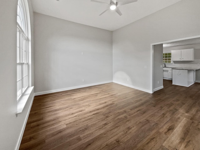 spare room with dark hardwood / wood-style floors and ceiling fan