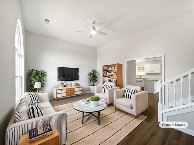 living room featuring hardwood / wood-style flooring and ceiling fan