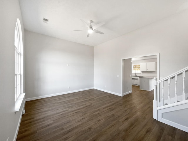 spare room with sink, ceiling fan, and dark hardwood / wood-style flooring