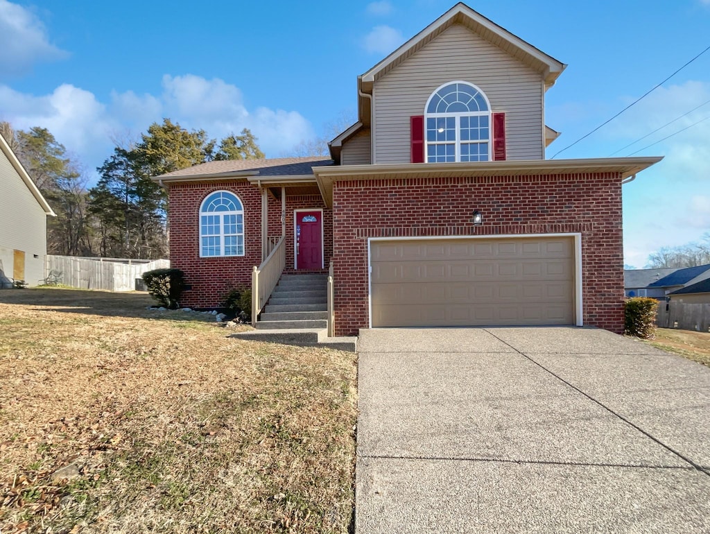 view of property featuring a garage and a front lawn