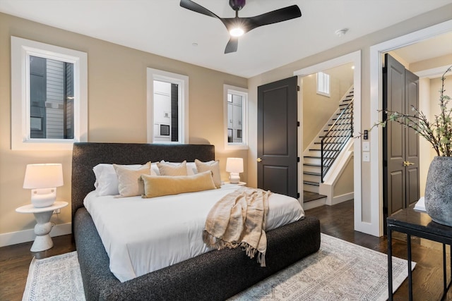 bedroom with ceiling fan and dark wood-type flooring