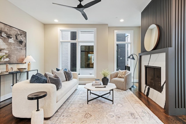 living room featuring hardwood / wood-style floors and ceiling fan