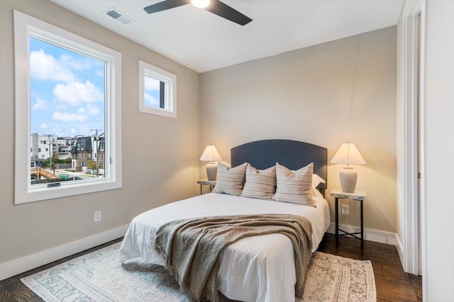 bedroom with ceiling fan and dark wood-type flooring