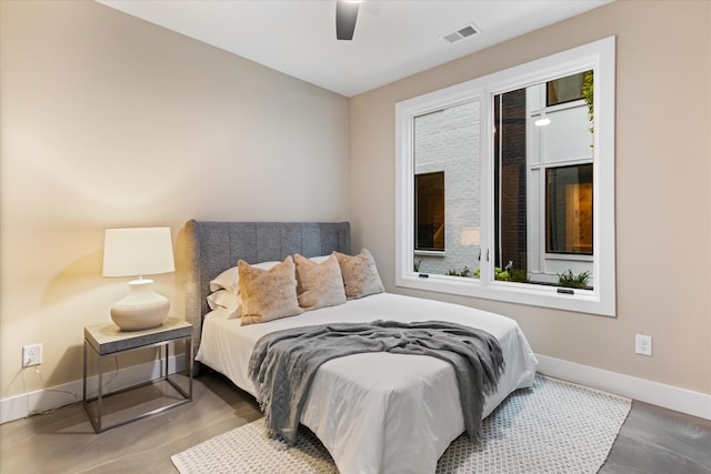 bedroom featuring multiple windows and ceiling fan