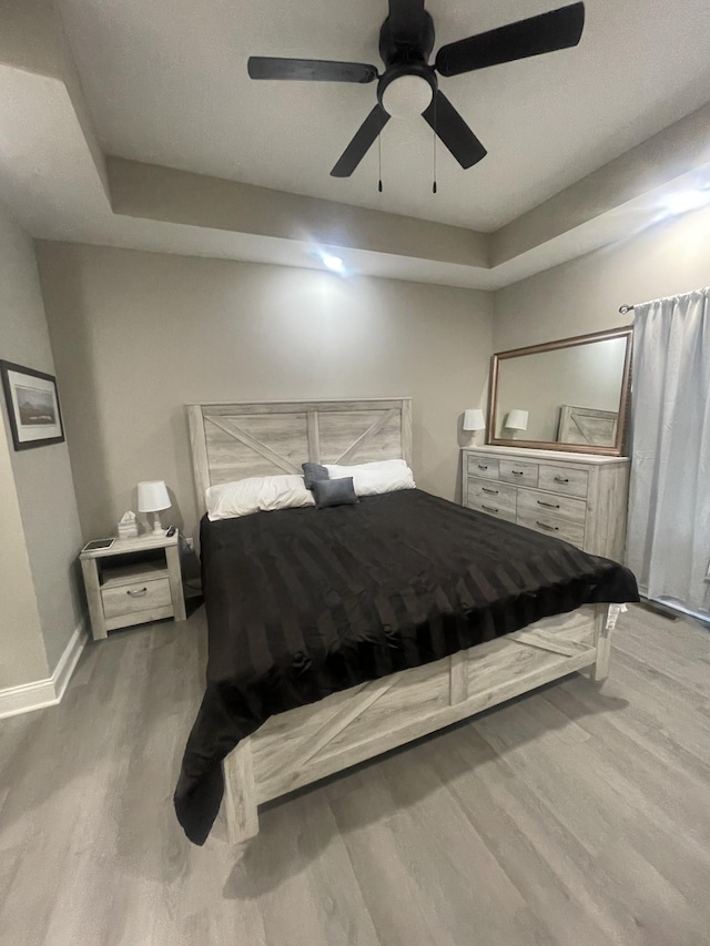 bedroom featuring ceiling fan and wood-type flooring