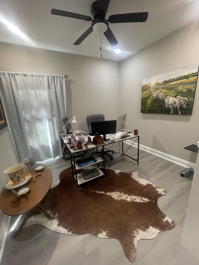 office featuring light wood-type flooring and ceiling fan