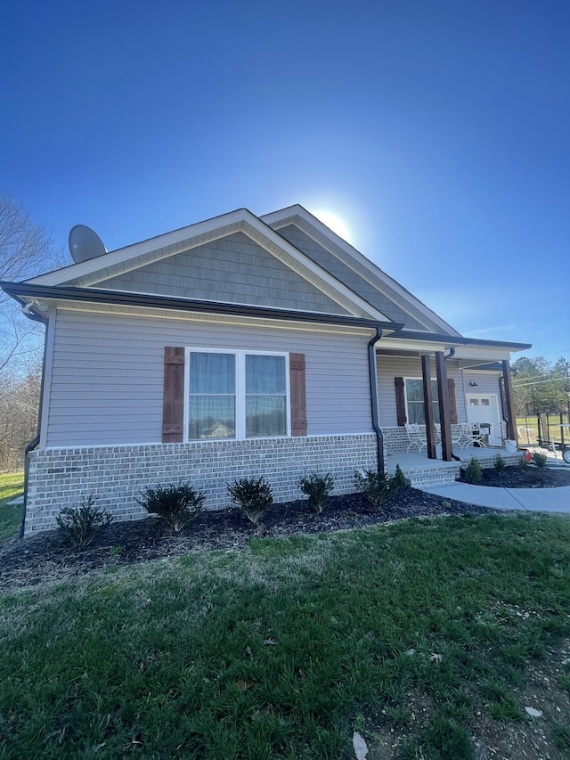 exterior space featuring a porch and a front lawn