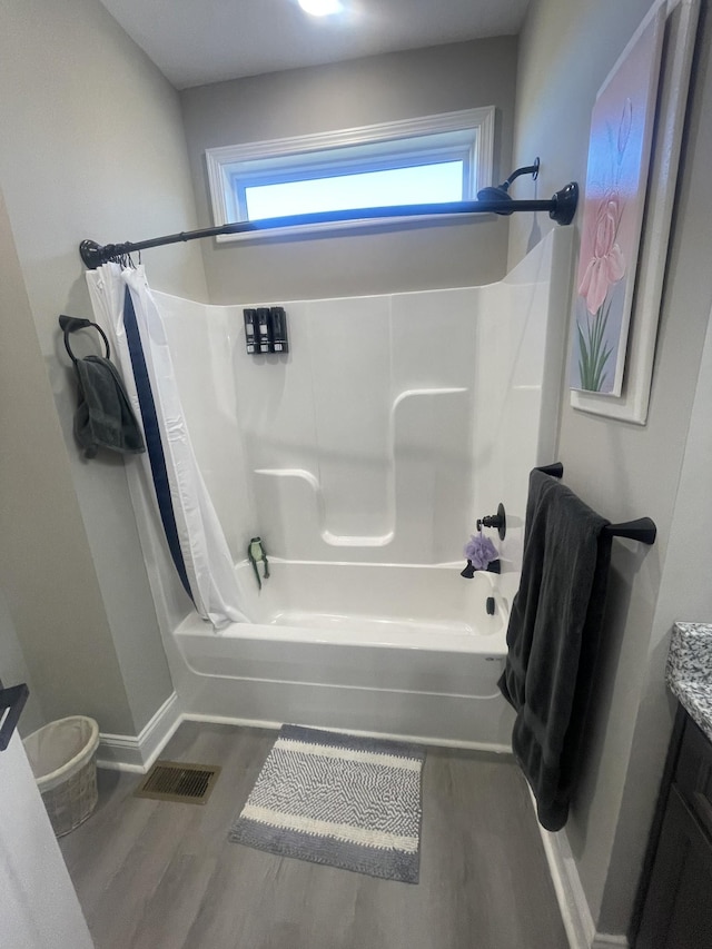 bathroom featuring vanity, wood-type flooring, and shower / tub combo