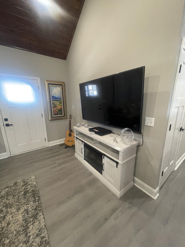 living room featuring hardwood / wood-style floors, high vaulted ceiling, and wood ceiling