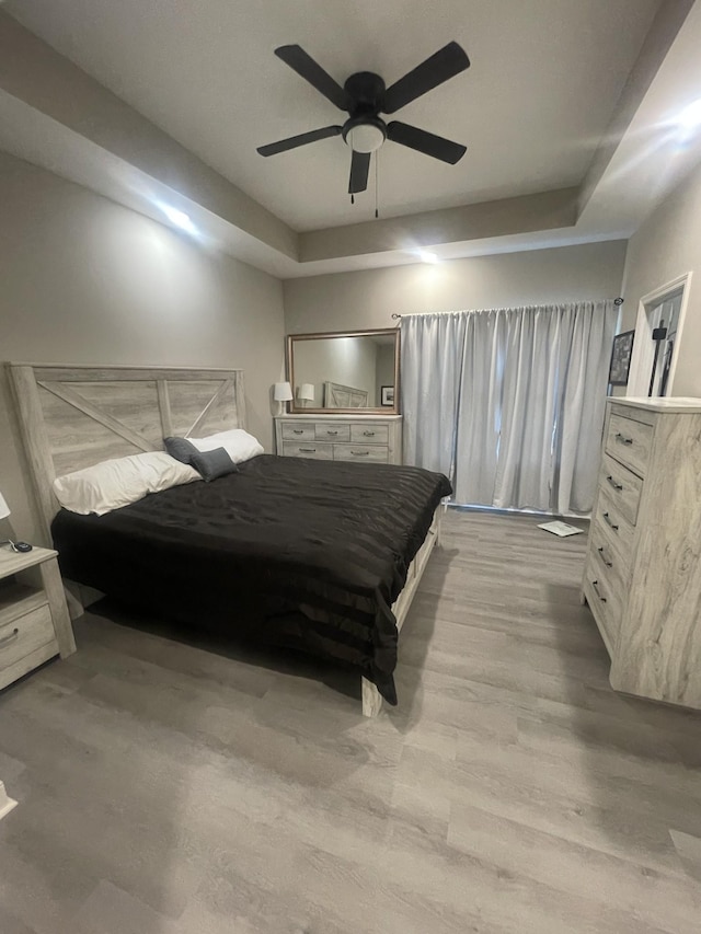 bedroom with light hardwood / wood-style floors and ceiling fan