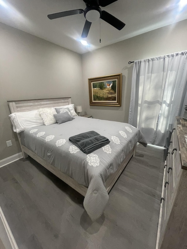 bedroom with ceiling fan and dark hardwood / wood-style flooring