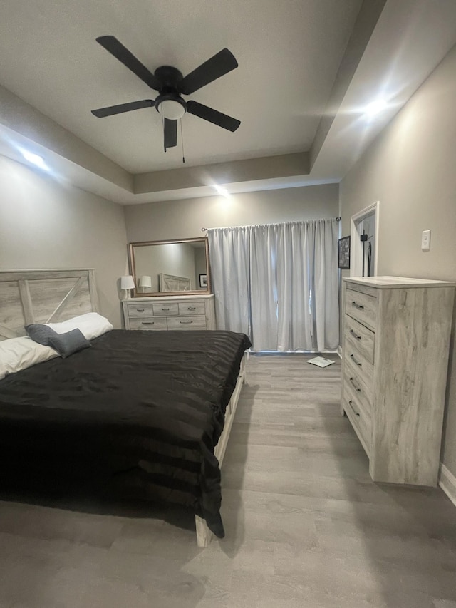 bedroom with ceiling fan and light hardwood / wood-style flooring