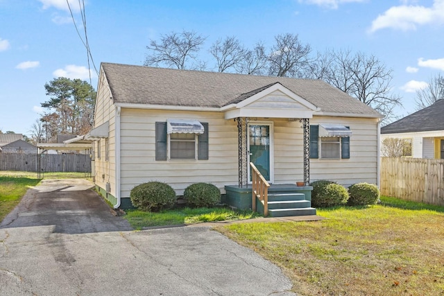 bungalow-style home with a front yard